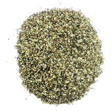 Load image into Gallery viewer, A pile of hemp heart fines, consisting of small flecks and particles ranging in color from cream to dark brown
