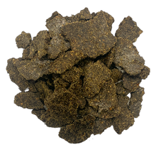 Load image into Gallery viewer, Flakes of pressed hemp cake in a pile on a white background
